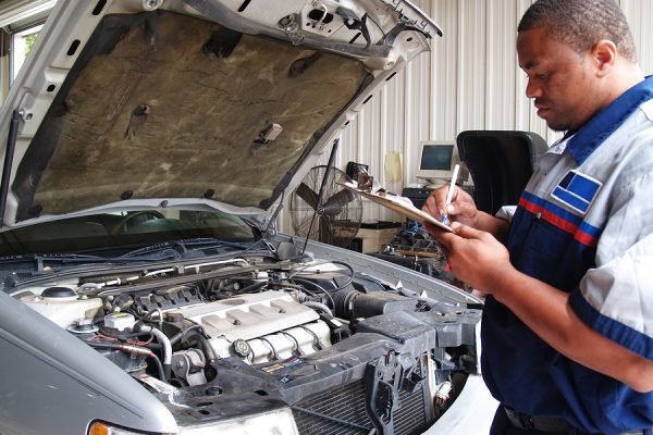 Mechanic Performing a Routine Service Inspection